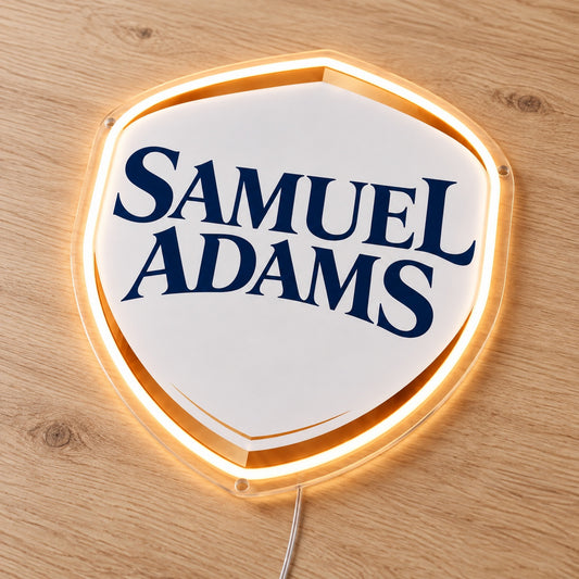 Samuel Adams LED Neon Sign, featuring illuminated beer-brand logo on a wooden surface.