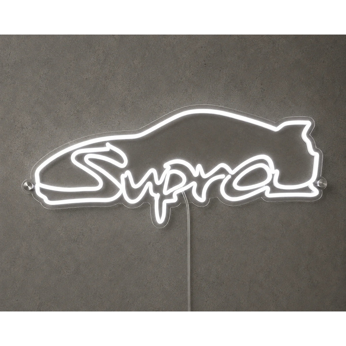 Toyota Supra Neon Sign in white, featuring Supra script logo with a car-roof outline on a grey wall.