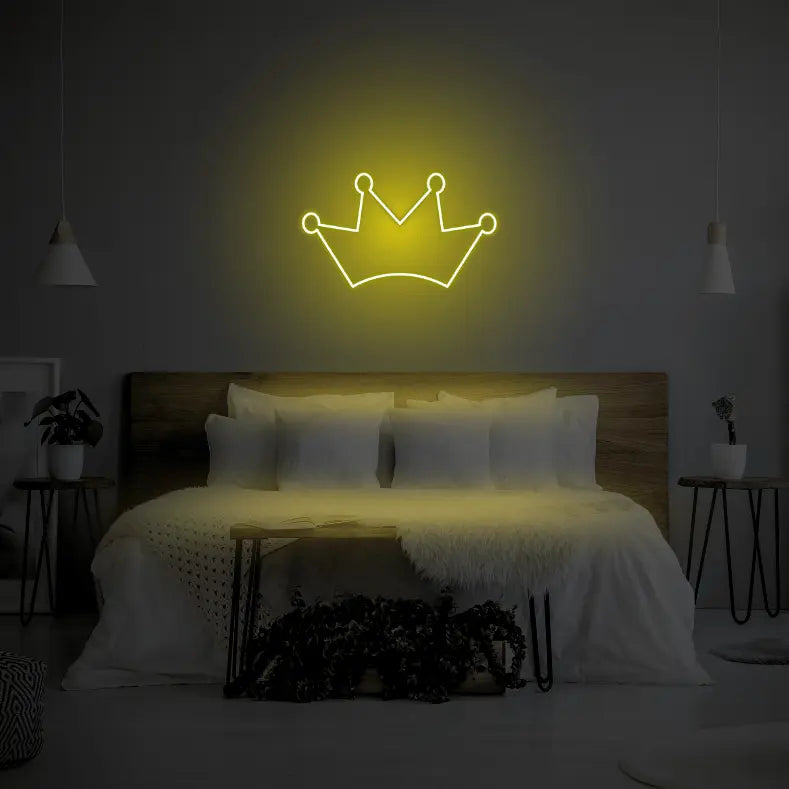 Crown LED Neon Light Sign in yellow, featuring crown outline illuminated above a bed.