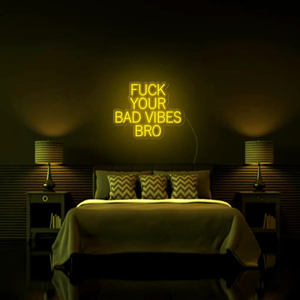 Fk Your Bad Vibes Bro LED Neon Sign in yellow, featuring stacked block lettering on a dark bedroom wall above a bed.