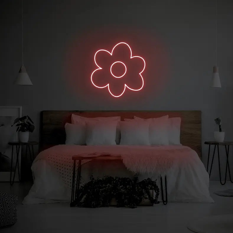 Flower LED Neon Light Sign in red, featuring flower outline illuminated above a bed.