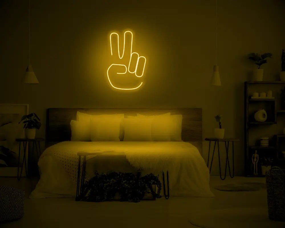 Peace LED Neon Light Sign in yellow, featuring hand making a peace sign, illuminated above a bed.