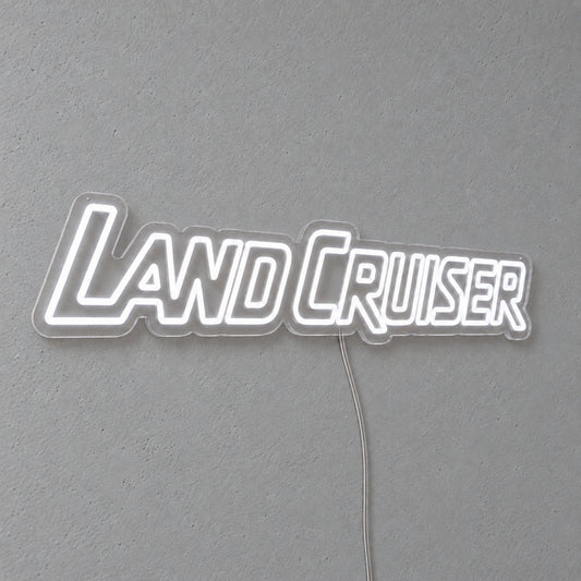 Toyota Land Cruiser LED Neon Sign in white, featuring Land Cruiser lettering on a grey wall.
