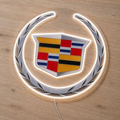 Cadillac LED Neon Sign, featuring illuminated vehicle logo on a wooden surface.