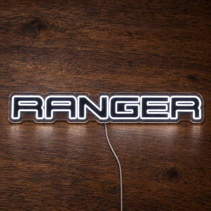 Ford Ranger LED Neon Sign in white, featuring Ranger lettering on a wooden surface.