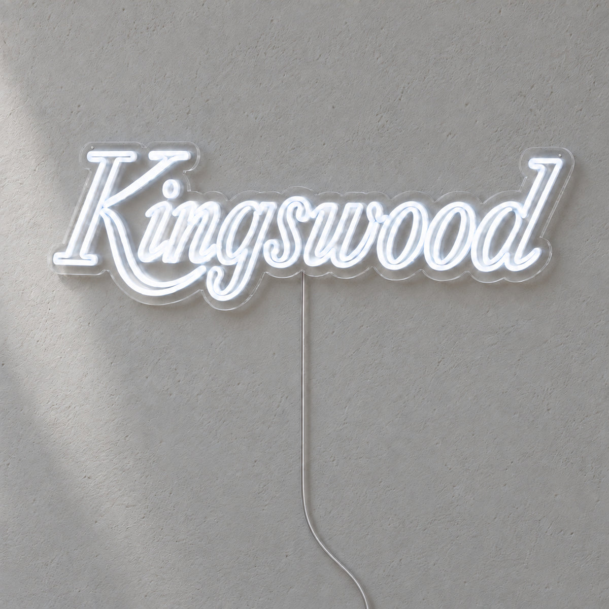 Holden Kingswood LED Neon Sign in white, featuring Kingswood script lettering on a grey wall.