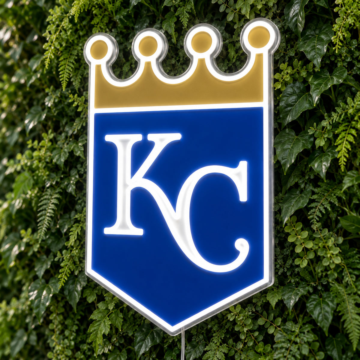 Kansas City Royals LED Neon Sign, featuring team logo displayed on a green foliage wall.