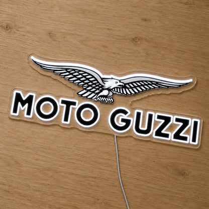 Moto Guzzi LED Neon Sign, featuring illuminated vehicle logo on a wooden surface.
