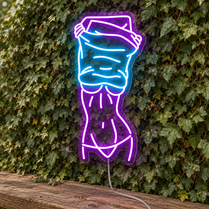 Nude Lady Man Cave Neon Sign - Garage & Home Bar Wall Sign in purple and turquoise, featuring a woman's outline against a foliage wall.