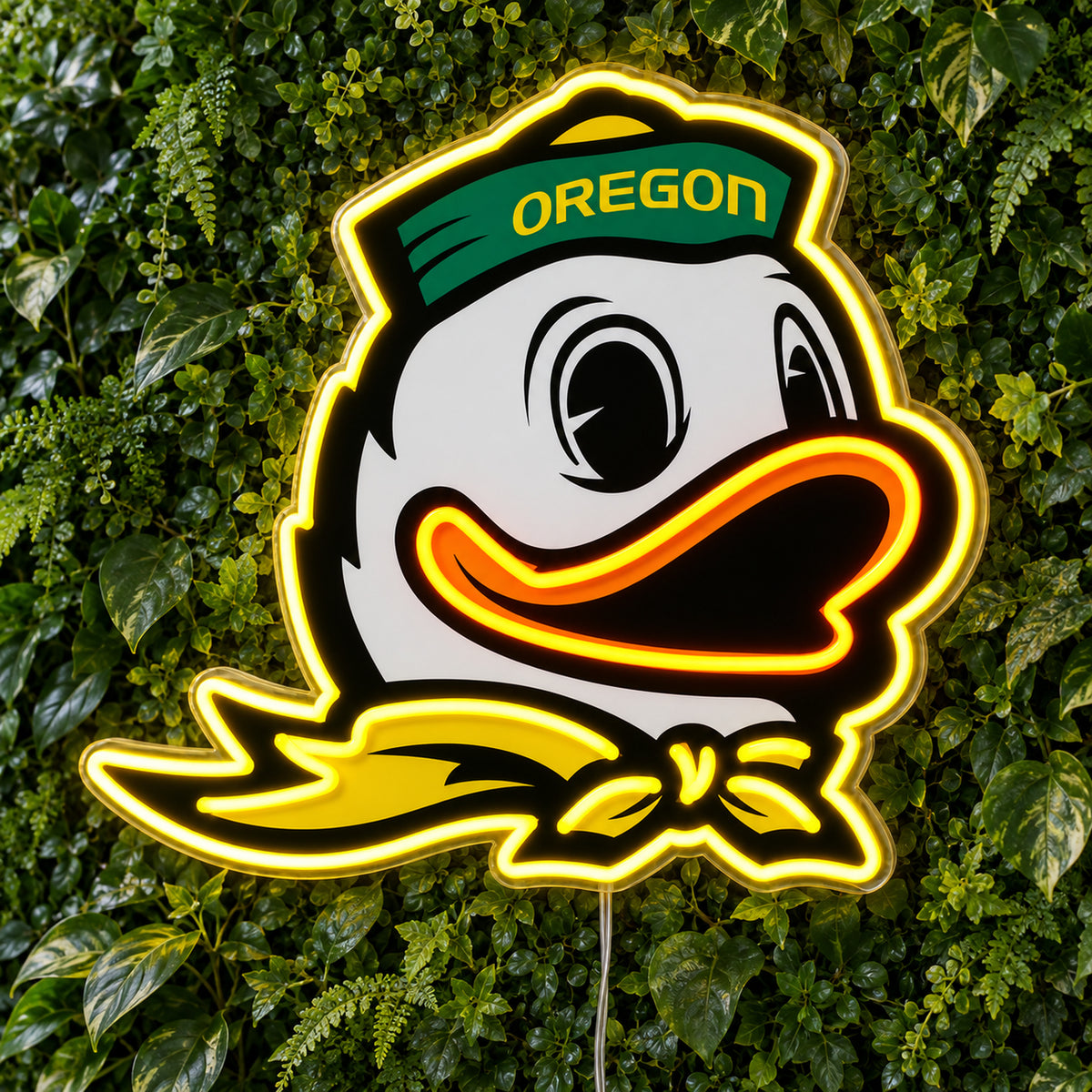 Oregon Ducks LED Neon Sign, featuring team logo displayed on a green foliage wall.