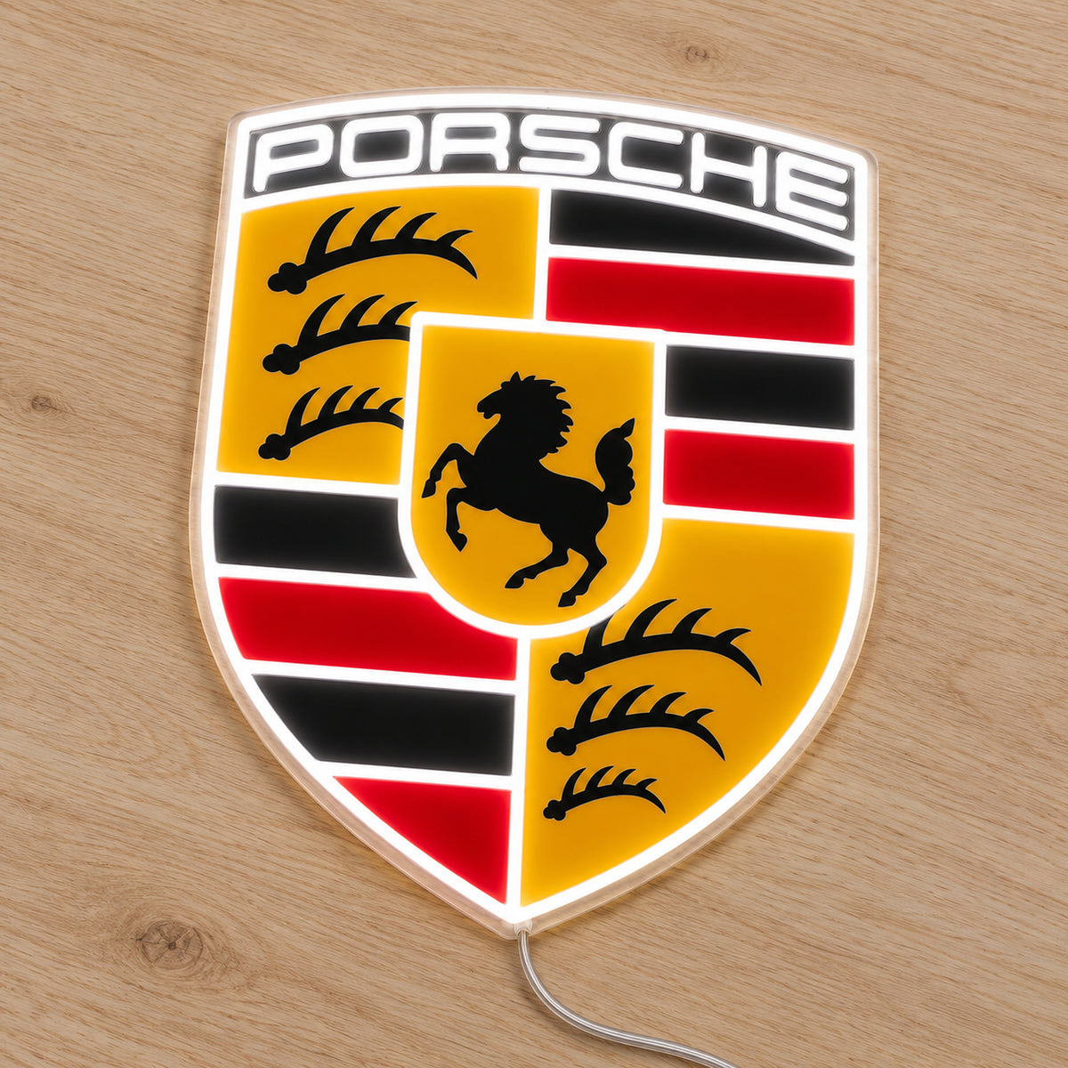 Porsche Crest LED Neon Sign, featuring vehicle-brand emblem displayed on a wooden surface.