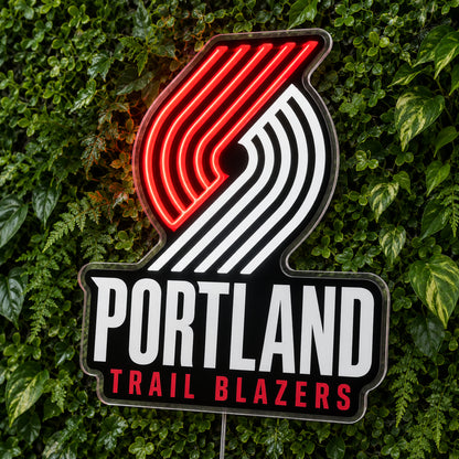 Portland Trail Blazers LED Neon Sign, featuring team logo displayed on a green foliage wall.