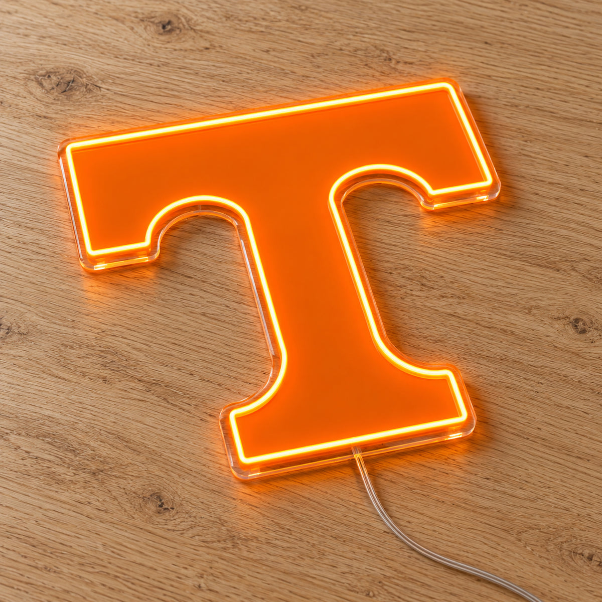 Tennessee Volunteers Power T LED Neon Sign, featuring team logo displayed on a wooden surface.