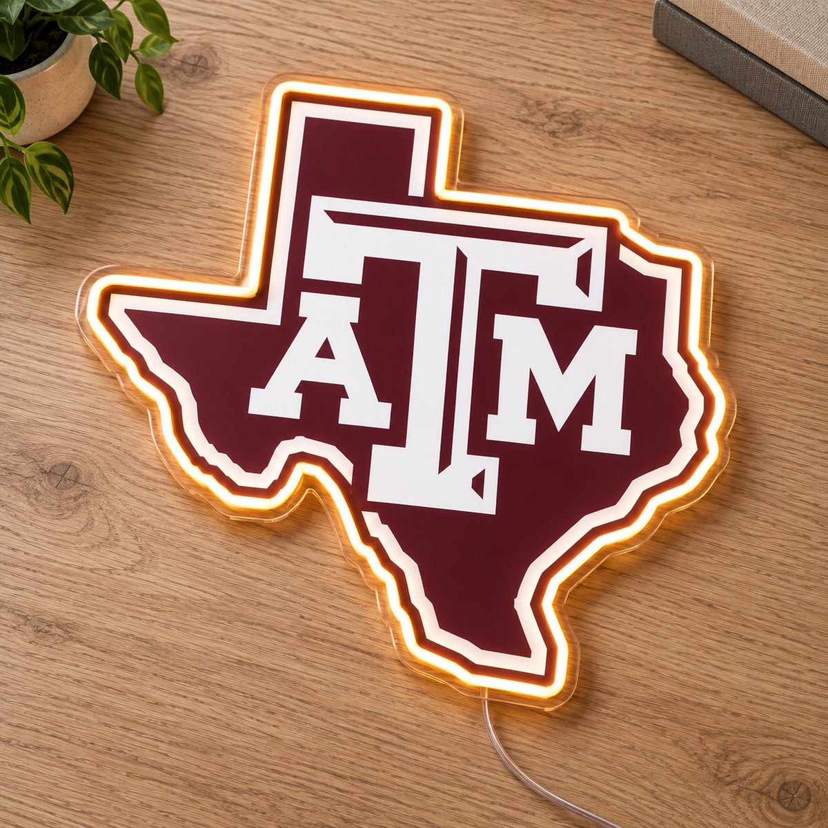 Texas A&M Aggies LED Neon Sign, featuring team logo displayed on a wooden surface.