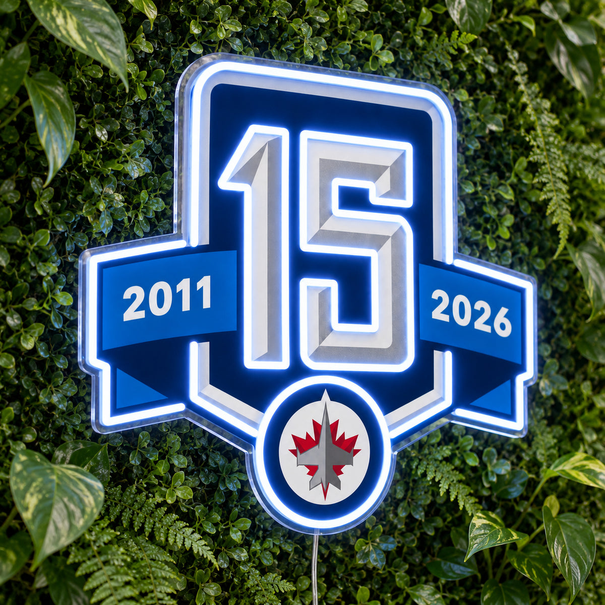 Winnipeg Jets 15th Anniversary LED Neon Sign, featuring team logo displayed on a green foliage wall.