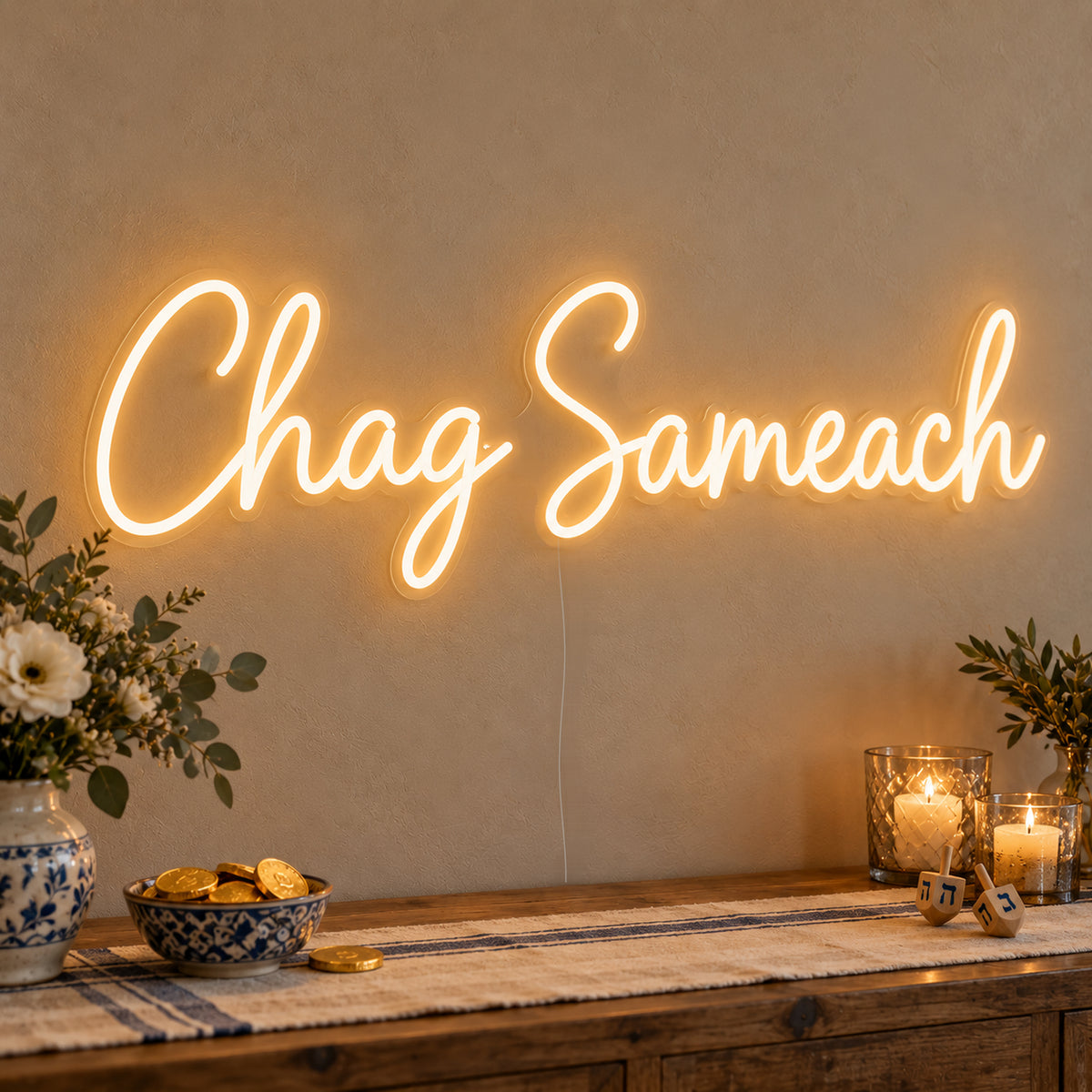 Chag Sameach Neon Sign on clear cut-to-shape acrylic, illuminated on a wall in a styled celebration setting