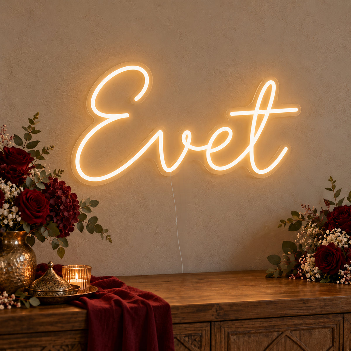 Evet Neon Sign on clear cut-to-shape acrylic, illuminated on a wall in a styled celebration setting