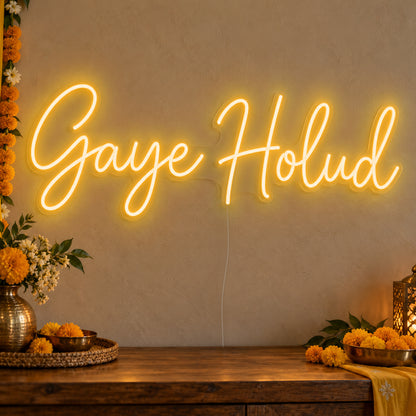 Gaye Holud Neon Sign in gold LED neon on clear acrylic, angled view