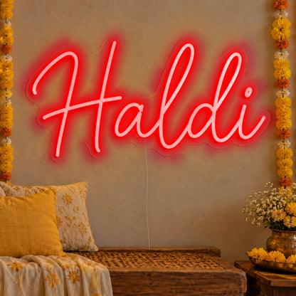Haldi Neon Sign in red LED neon on clear acrylic, angled view