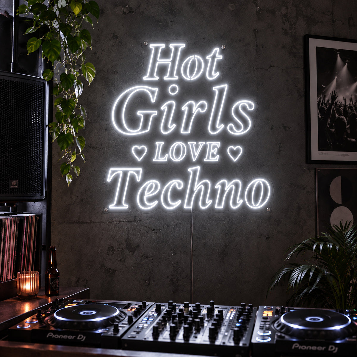 Hot Girls Love Techno Neon Sign glowing white with heart details above a DJ setup.