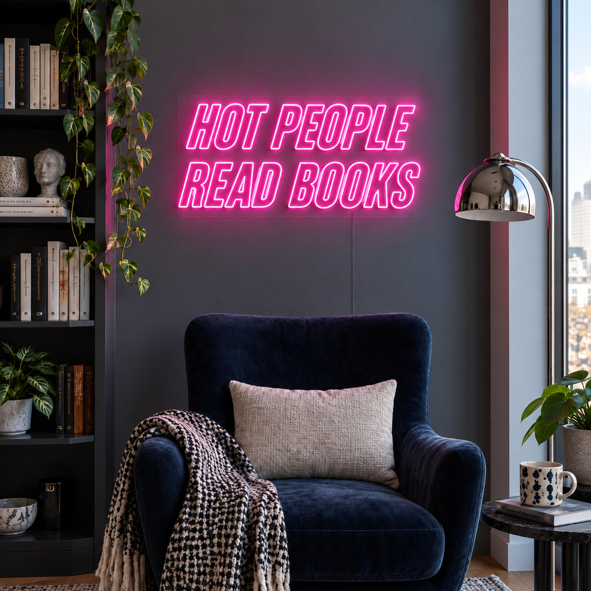 Hot People Read Books Neon Sign glowing pink above a blue reading chair.