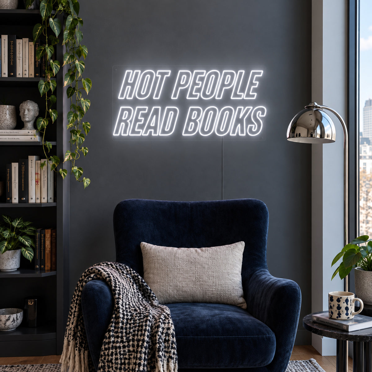 Hot People Read Books Neon Sign glowing white above a blue reading chair.