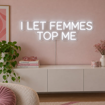 I Let Femmes Top Me Neon Sign, RGB colour-changing option shown in white in rounded lettering above a white sideboard.