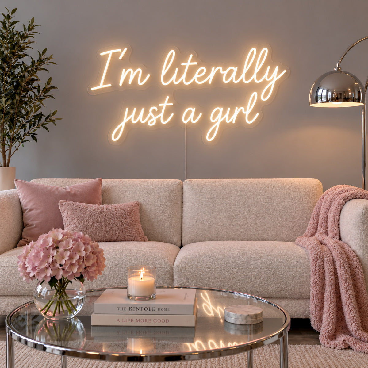 Warm White version of the I'm Literally Just A Girl Neon Sign, shown above a cream sofa.