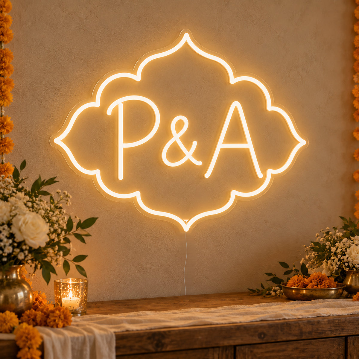 Personalised Marigold Initials Neon Sign on clear cut-to-shape acrylic in an illuminated wall display; example personalisation shown.