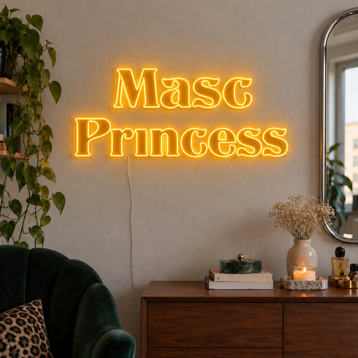 Masc Princess Neon Sign glowing gold above a wooden sideboard beside a green chair.