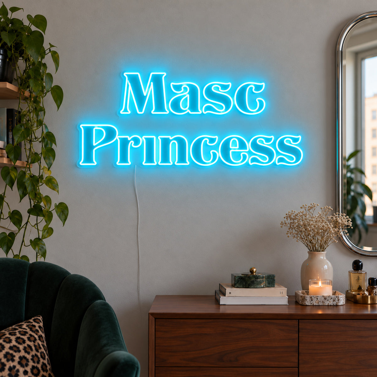Ice Blue version of the Masc Princess Neon Sign, shown above a wooden sideboard beside a green chair.