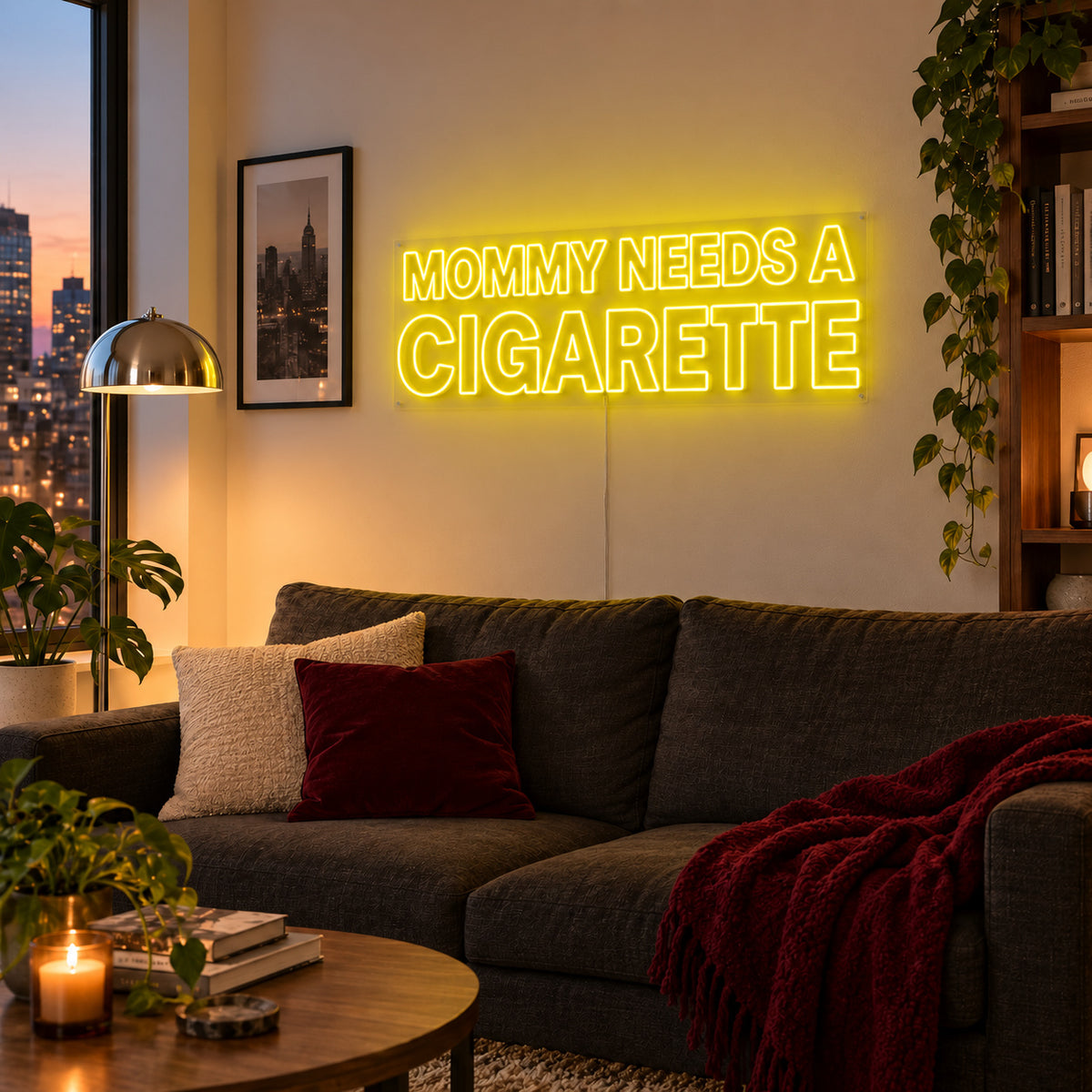 Mommy Needs A Cigarette Neon Sign with yellow lighting, displayed above a brown sofa.