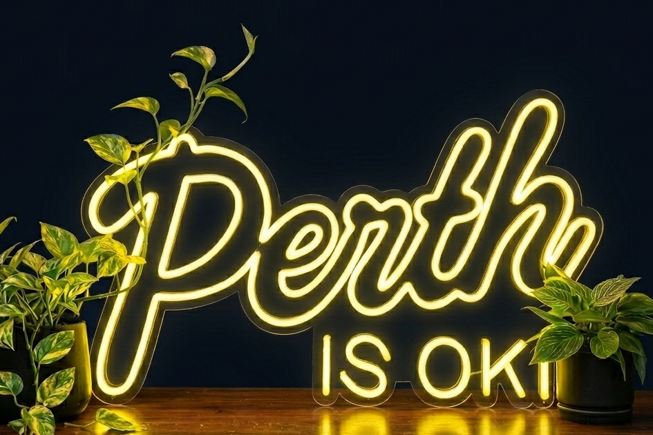 Perth is OK! neon sign on a dark background with plants, shown as custom sign inspiration for Mandurah.