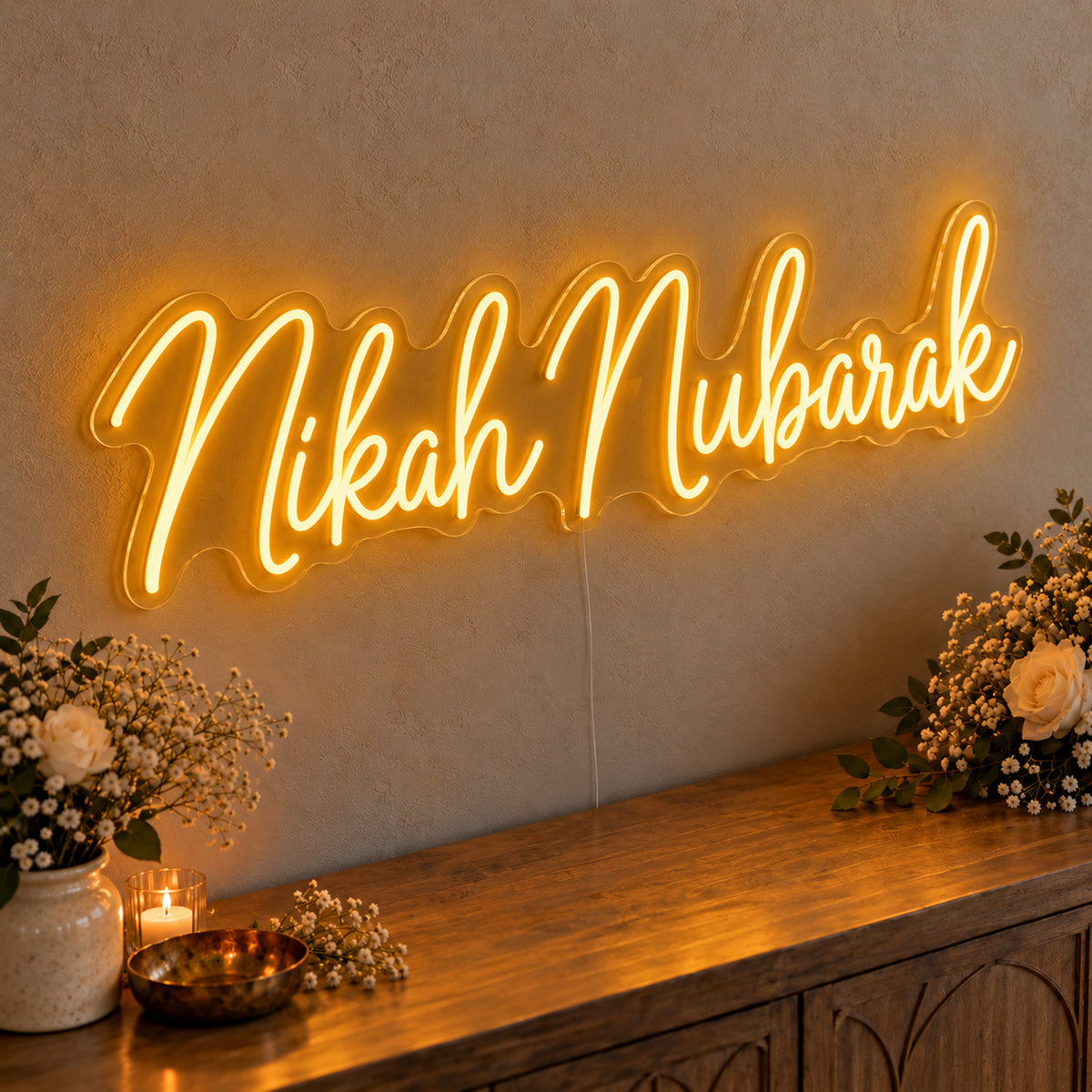 Nikah Mubarak Neon Sign in gold LED neon on clear acrylic, angled view