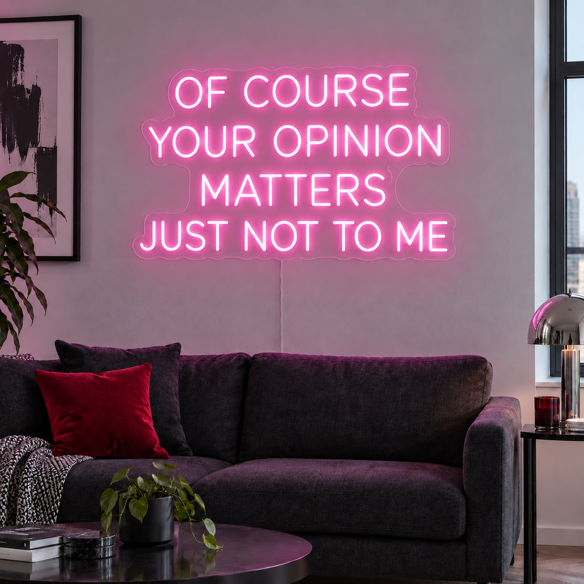 Of Course Your Opinion Matters Just Not To Me Neon Sign glowing pink above a black sofa.