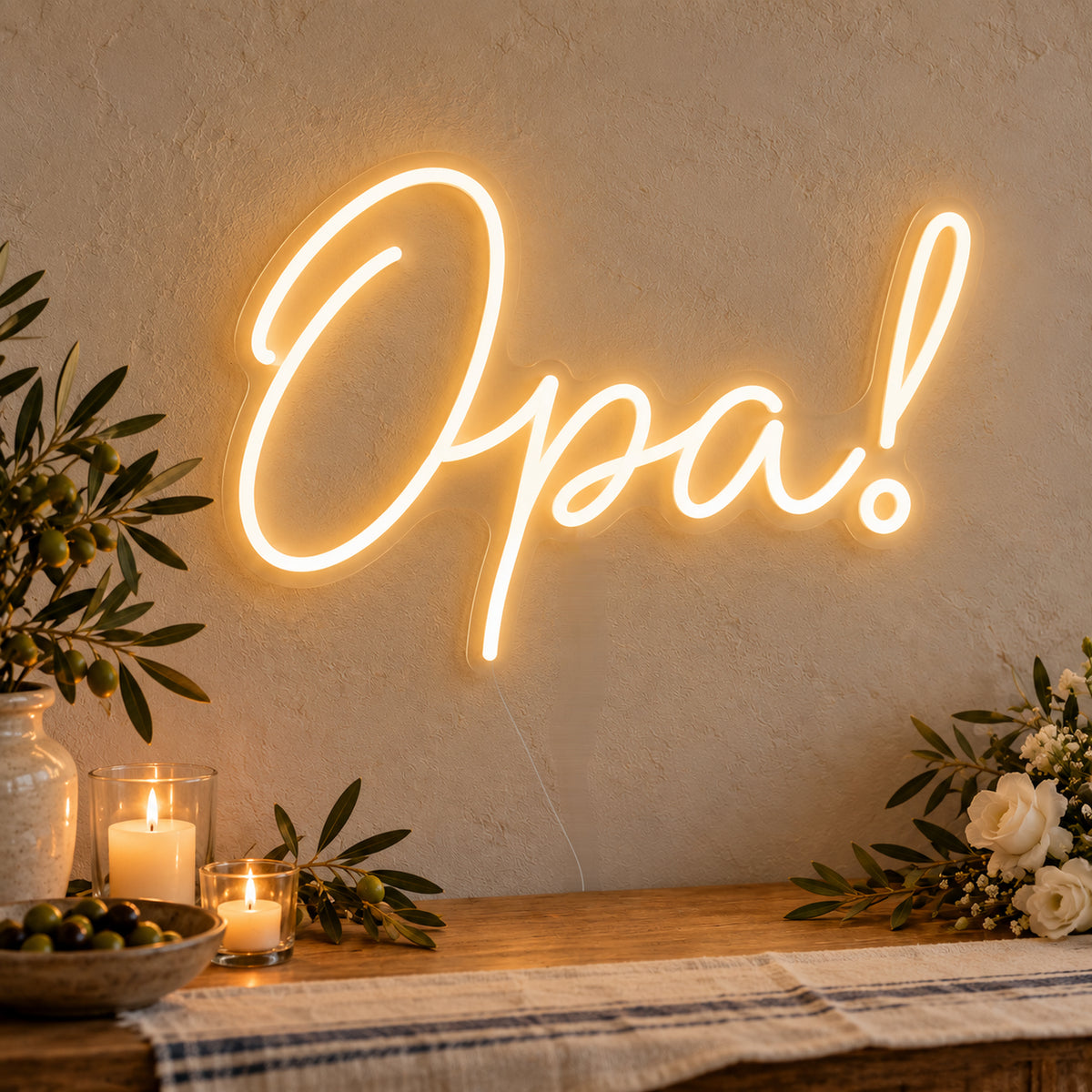 Opa Neon Sign on clear cut-to-shape acrylic, illuminated on a wall in a styled celebration setting