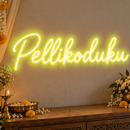 Pellikoduku Neon Sign in yellow LED neon on clear acrylic, angled view