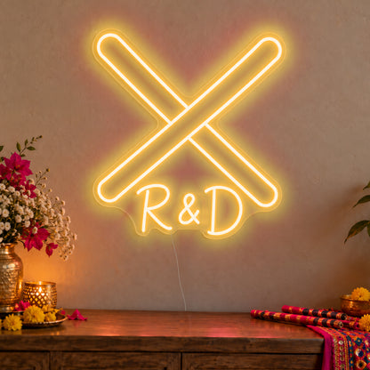 Personalised Dandiya Initials Neon Sign in gold LED neon on clear acrylic, angled view
