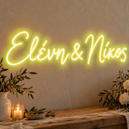 Personalised Greek Couple Names Neon Sign in yellow LED neon on clear acrylic, angled view