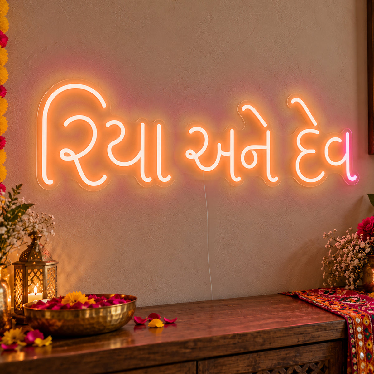Personalised Gujarati Couple Names Neon Sign in orange LED neon on clear acrylic, angled view