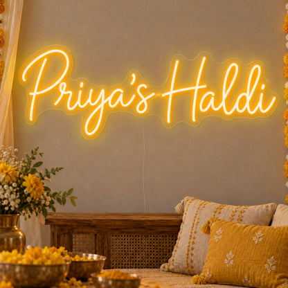 Personalised Haldi Neon Sign in gold LED neon on clear acrylic, angled view