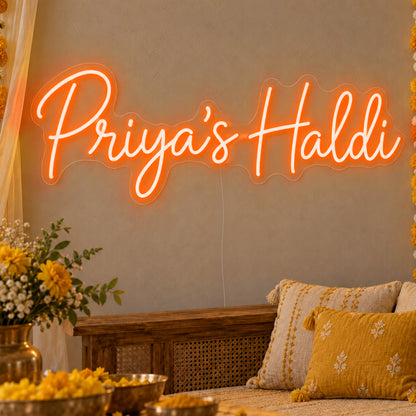 Personalised Haldi Neon Sign in orange LED neon on clear acrylic, angled view
