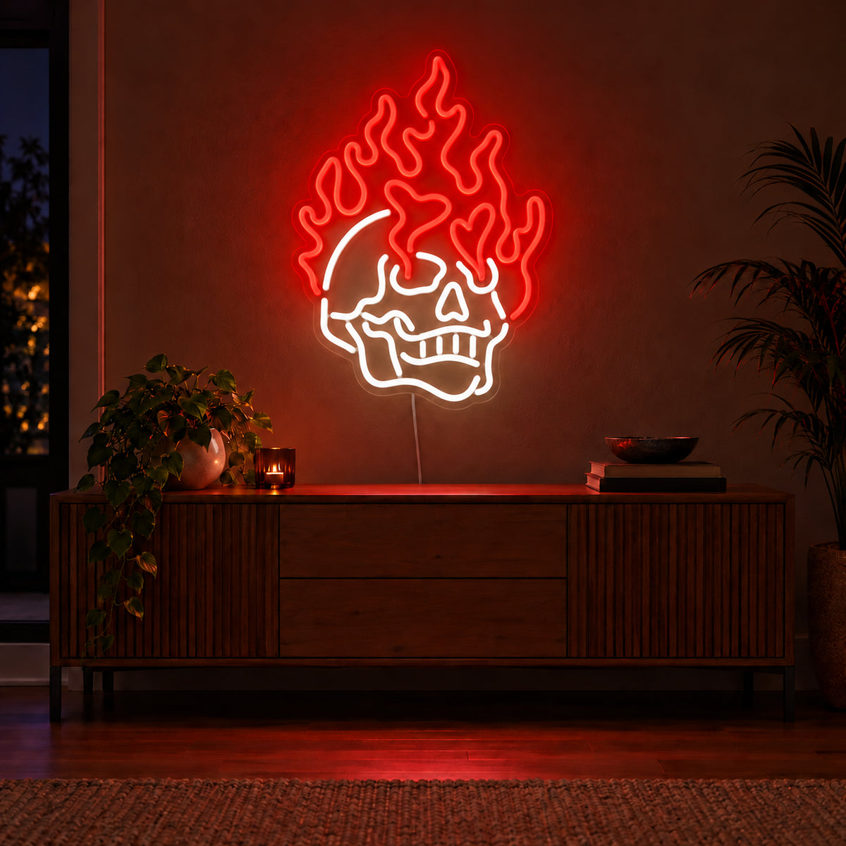 Red Flaming Skull Neon Sign with red flames and white skull, illuminated on a wall above a wooden sideboard.