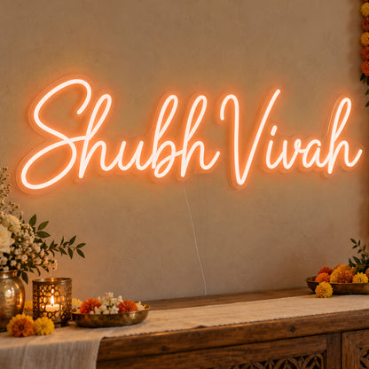 Shubh Vivah Neon Sign in orange LED neon on clear acrylic, angled view