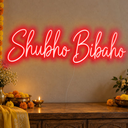 Shubho Bibaho Neon Sign in red LED neon on clear acrylic, angled view