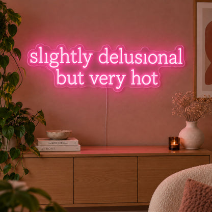 Slightly Delusional But Very Hot Neon Sign glowing pink above a wooden sideboard.